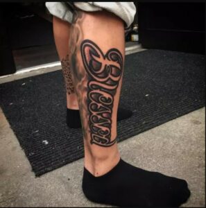 Blessed Tattoo on Leg with a Religious Symbol 